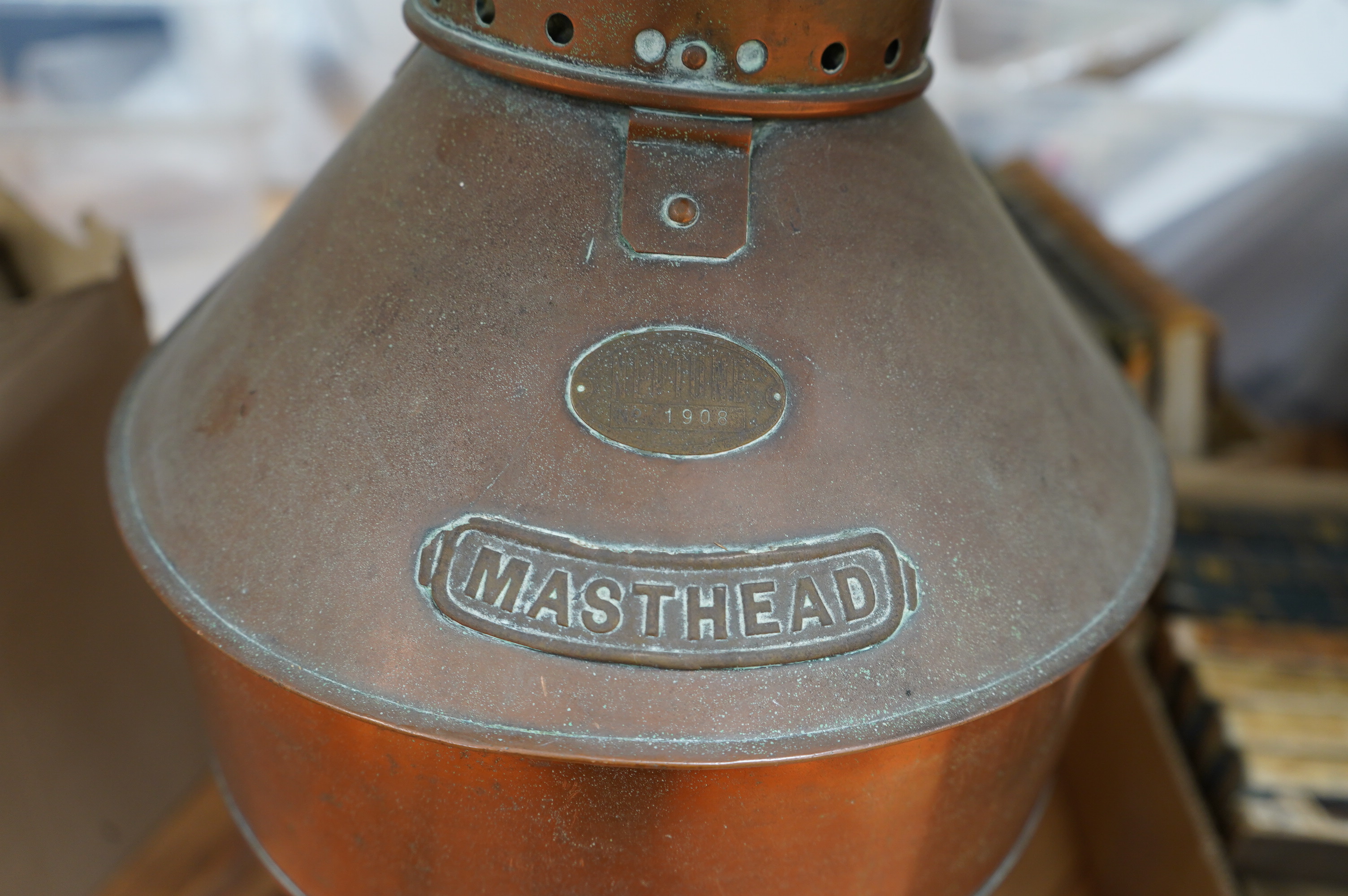 An early 20th century ship’s copper mast head lamp, 69cm high. Condition - fair